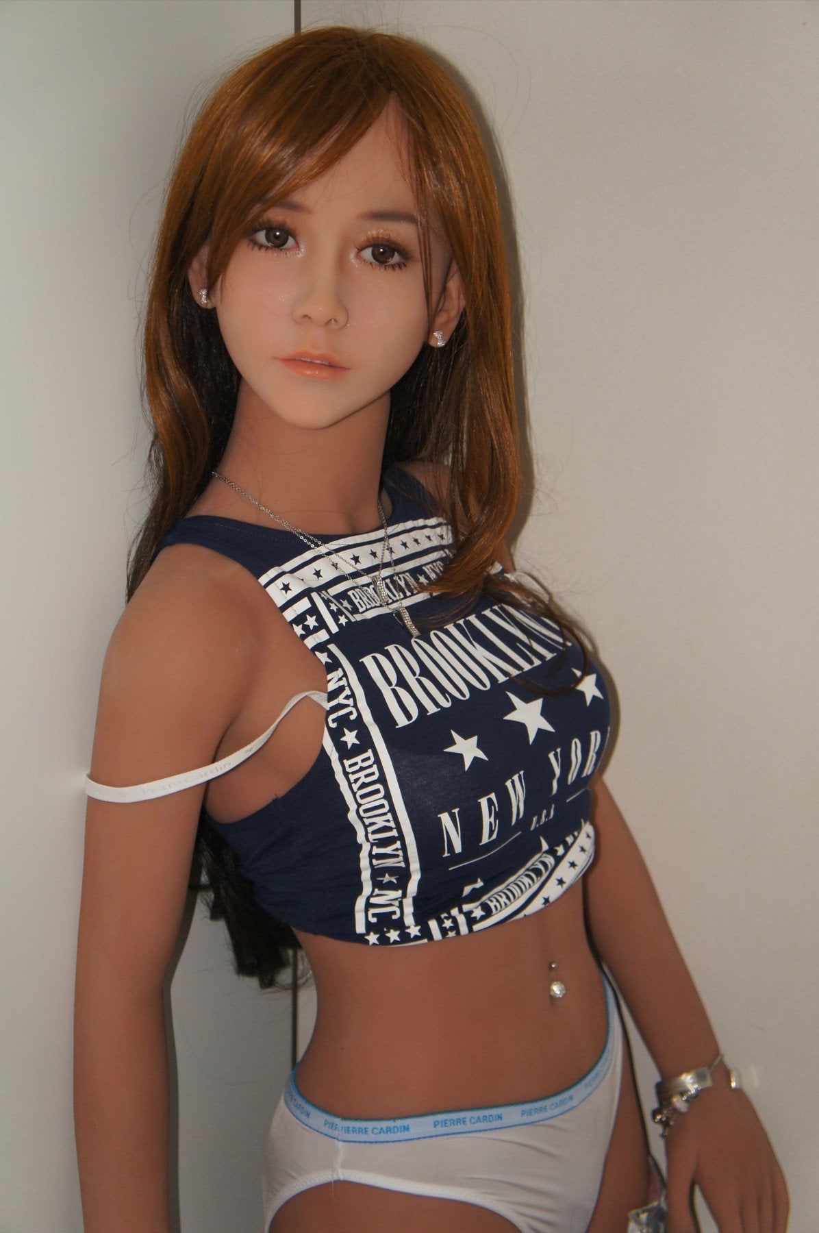 A doll with a slim body, perky hips, and plump breasts and buttocks, as well as a face-thinning realistic doll