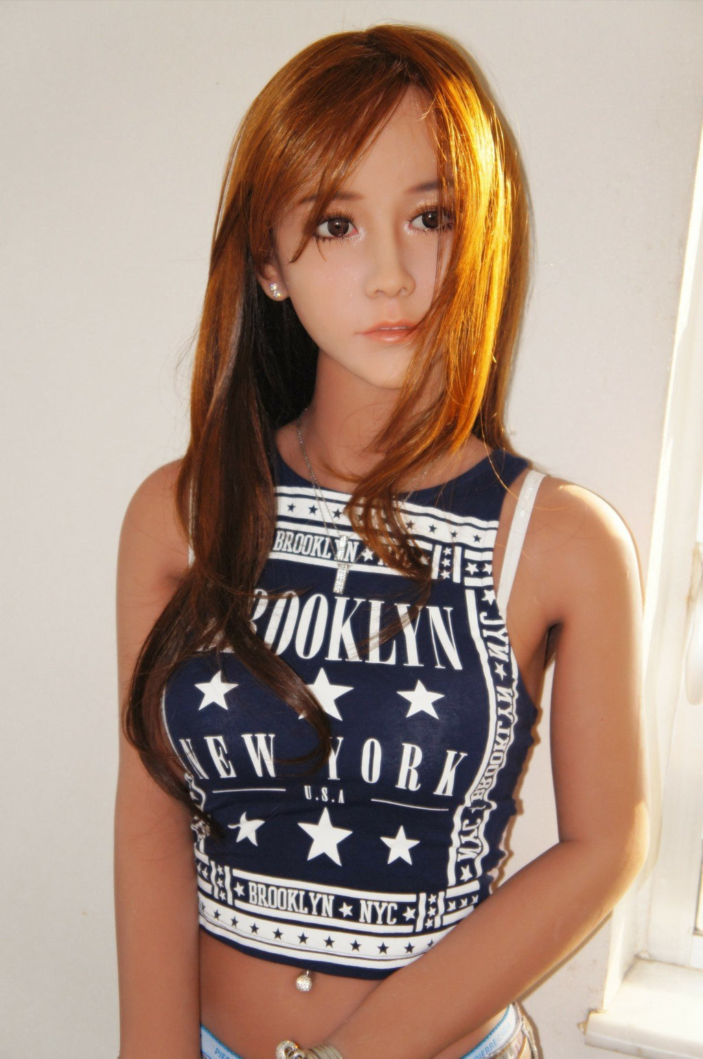 A doll with a slim body, perky hips, and plump breasts and buttocks, as well as a face-thinning realistic doll