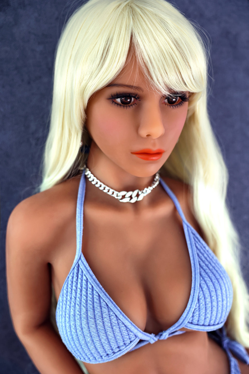 Cute and sexy doll with big breasts and buttocks, resembling a real person