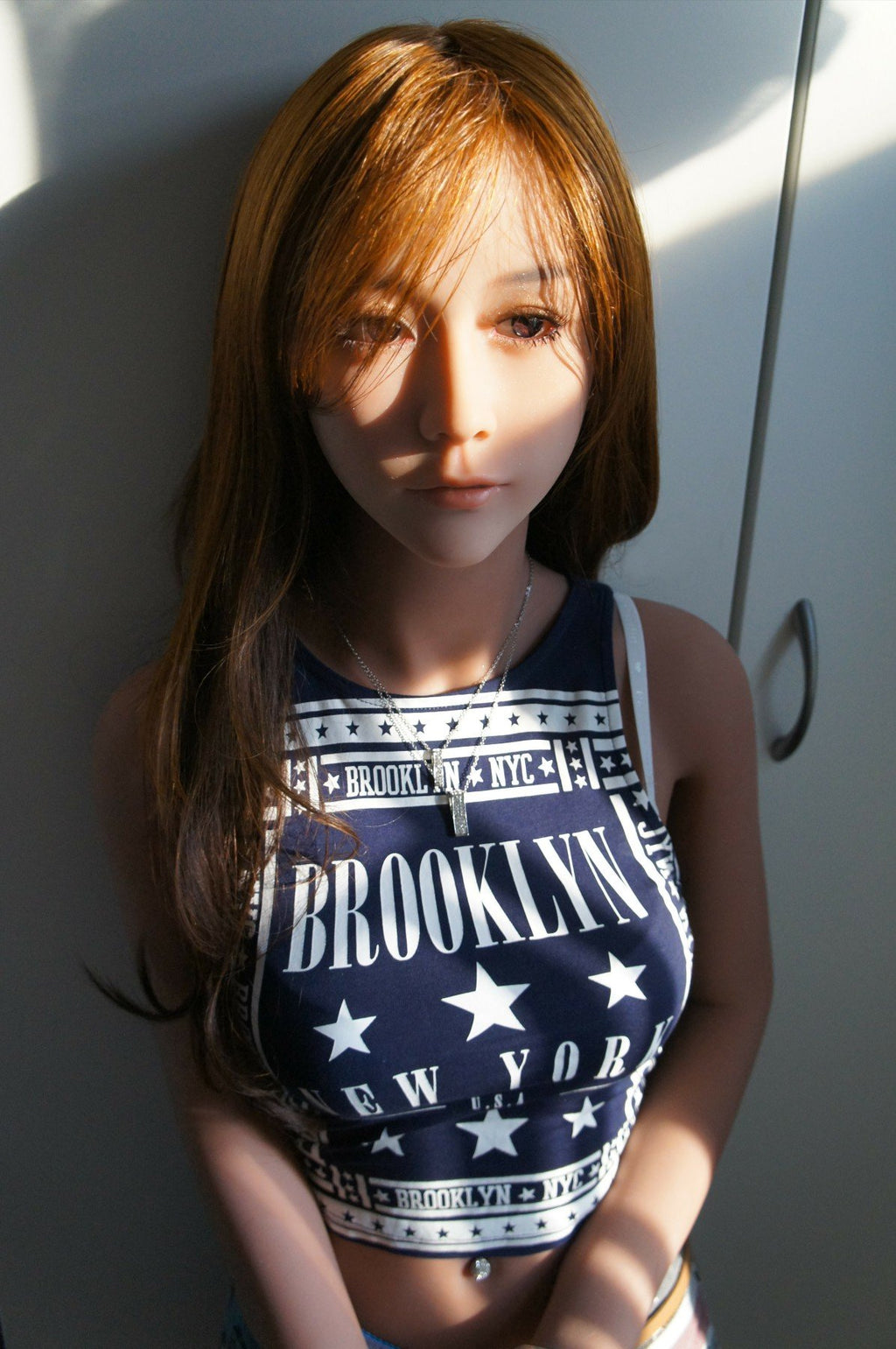 A doll with a slim body, perky hips, and plump breasts and buttocks, as well as a face-thinning realistic doll